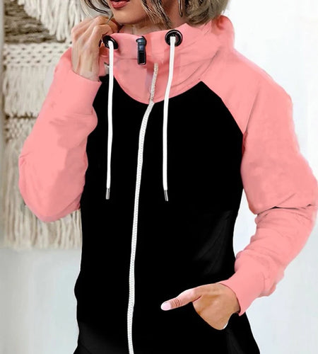Person wearing a black and pink hoodie with white drawstrings.