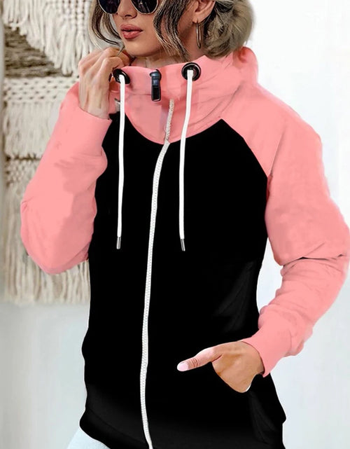Load image into Gallery viewer, Person wearing a black and pink hoodie with white drawstrings.
