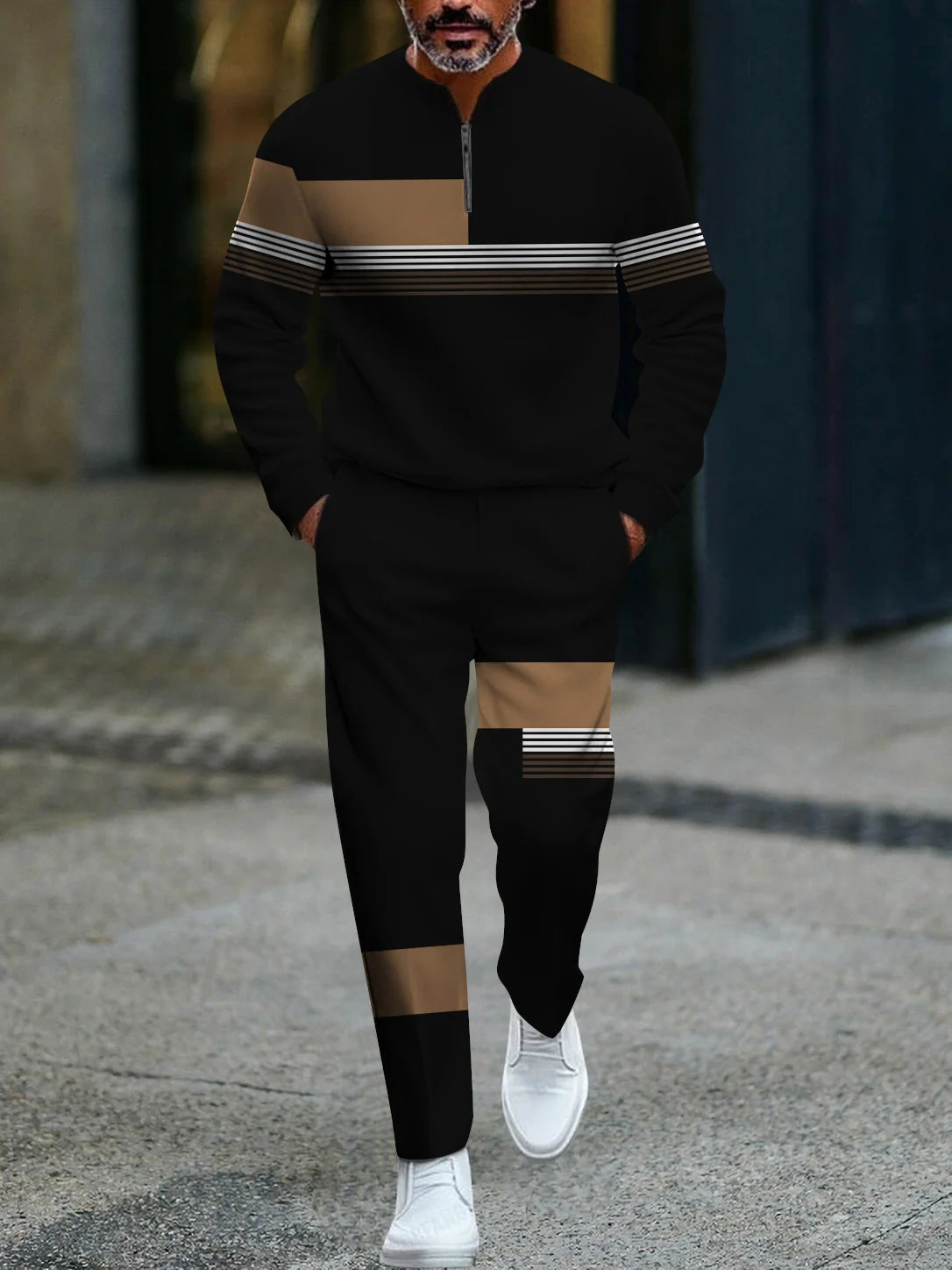Man wearing a black and brown striped tracksuit with white sneakers on a street.