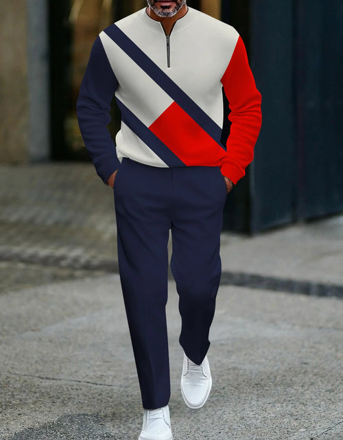 Load image into Gallery viewer, Person wearing a colorful sweater and navy pants walking on a street.

